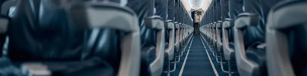 Looking down the central aisle of an empty airplane
